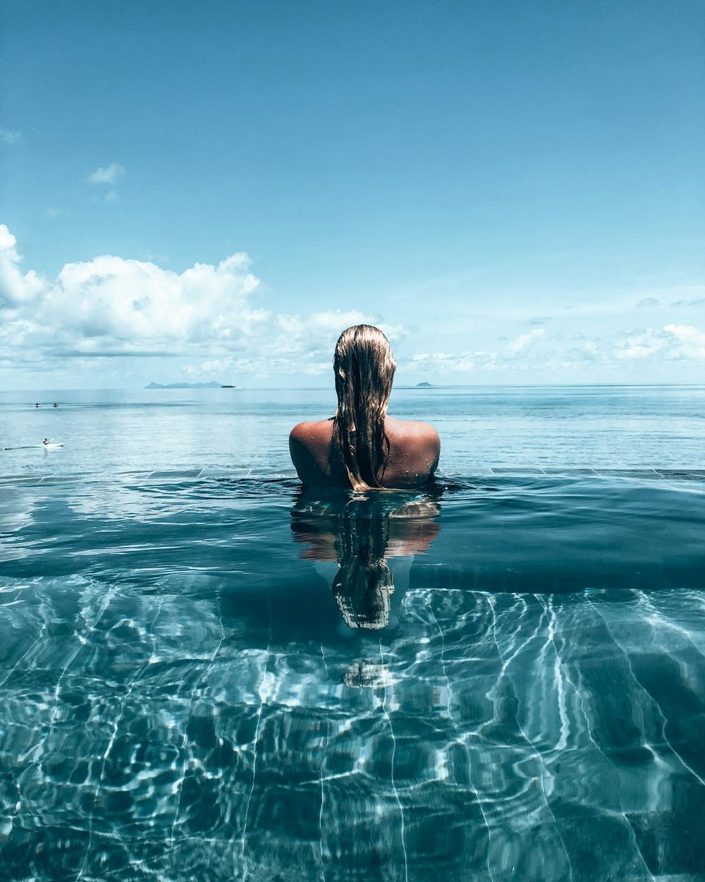 Standing waist-deep in clear water